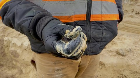 Construction worker wearing nitrile gloves rubbing pipe lube  grease between fingers. Slow Motion.