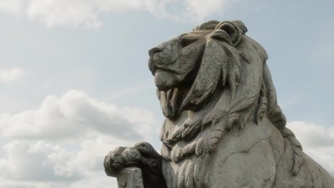 Slow pan on a majestic lion statue, hyperrealistic animation
