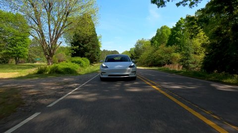 RALEIGH, NC USA, APRIL 20, 2020: A new Tesla Model 3 driving down the road