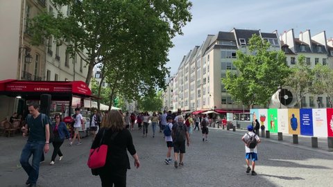 PARIS - CIRCA AUGUST, 2019: Footage of people walking on street next to contemporary art museum called "Centre Pompidou" in Paris. It is a sunny summer day. Camera moves forward.
