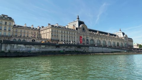PARIS - CIRCA AUGUST, 2019: Footage of famous art museum called "Musee d'Orsay" by Seine river in Paris. It is a sunny summer day. Camera moves forward.