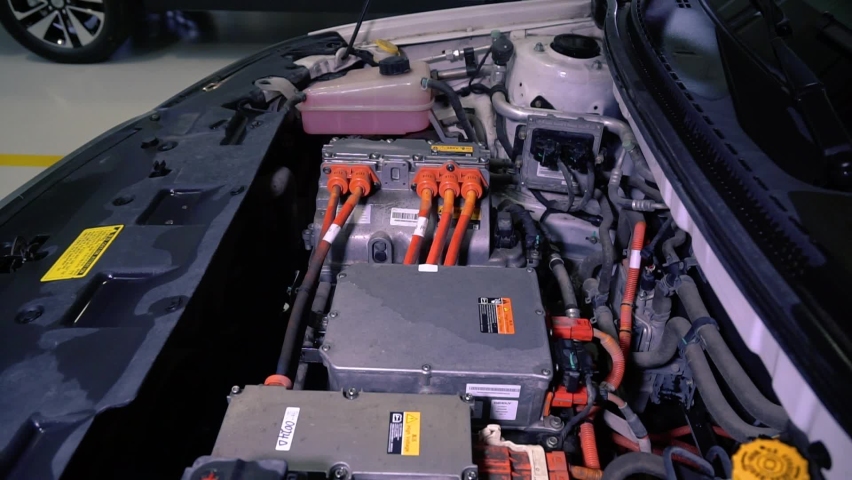 Close up detailed view of electric car engine in factory. Electric equipment of the a Japanese manufactured showing in a car showroom. Diagnostics and repair original spare parts. Saving the planet