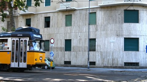  Vintage public streetcar for passenger transport on rails next to Polytechnic University of Milan in Italy  - Real time 4K