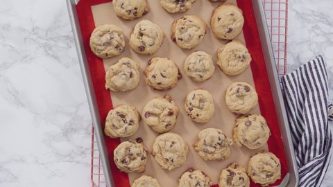 Step by step. Flat lay. Freshly baked homemade soft chocolate chip cookies on a baking sheet.