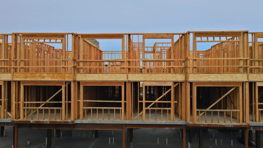 Wood home framing at construction site with wooden truss framework Royalty-Free Stock Footage #1063377709