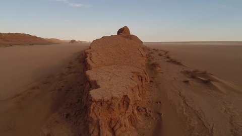 dolly shot from the formation of sandstones in dasht e lut desert at the morning, aerial close up shot the formation of kalut in shahdad desert, iran