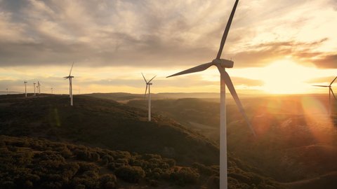 Scenic Aerial view of wind turbines farm in sunset time. High quality 4k footage