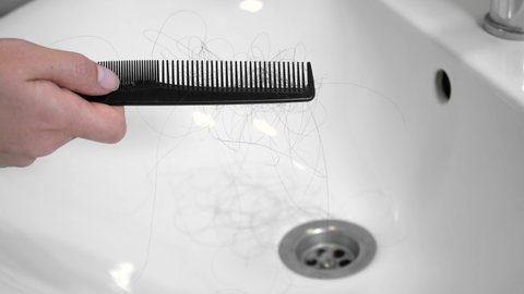 Hair left on the comb after brushing the hair. Hair loss problem