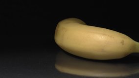 Banana close-up. Fruit on a black background.