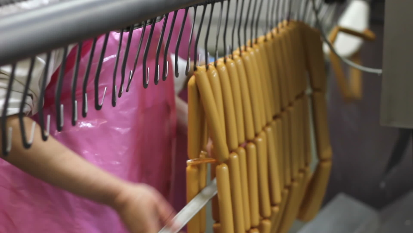 Production of hot dogs in a factory, people working in food processing plant