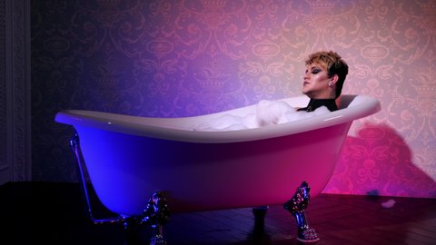 Relax transsexual take bath neon light. Makeup queer trans lgbt. Bathing froth bisexual man. Transgender. Gay transvestite spa. Cosmetic foam homosexual trans. Gender transsexualism lgbtq people.