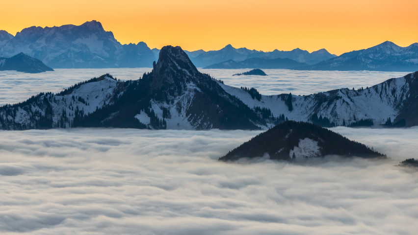 Sunset cloud movements A sea of fog is formed from stratus. Above the clouds over. Flat surface.Alps mountain sunrise time lapse nature landscapes zugspitz, alpspitz mountain.