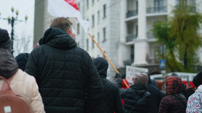 Political protest. White-red-white color flag Belarus. Crowd belarusian people. Belorussia strikes. Belorussian activists. Revolution flags. Byelorussian activism. Politics protesting Byelorussia. Royalty-Free Stock Footage #1063391914