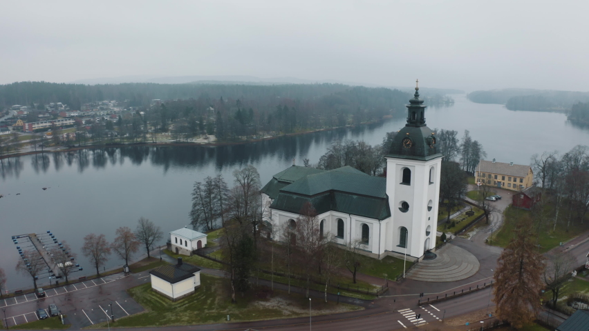 4k aerial drone shot of the christian church of Filipstad Sweden in a foggy day .