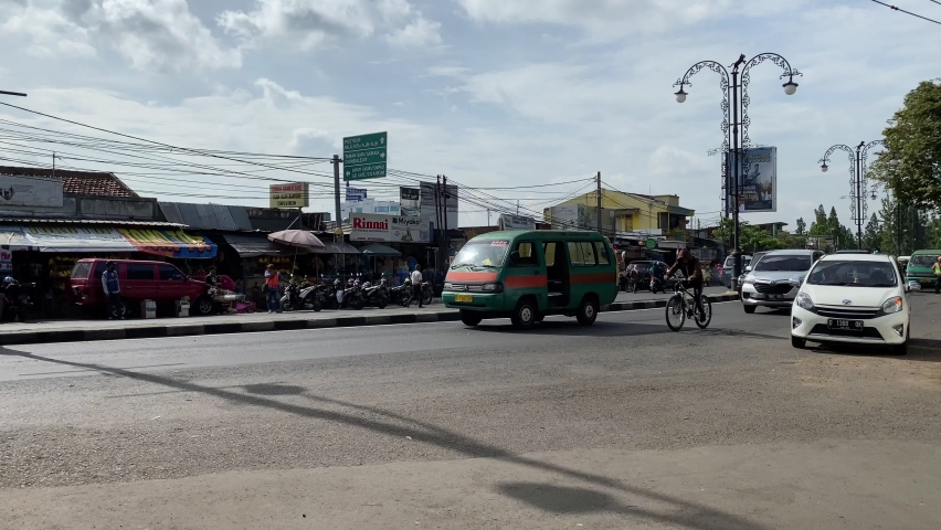 Angkot public transportation and cars passing through Pasar Simpang Dago Bandung