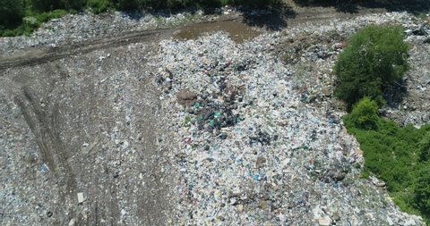 Aerial top view of Illegal garbage dump in the middle of the green forest. Ecological Problem Concept Landfill in forest
