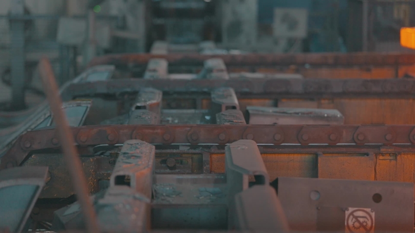 Hot metal on a conveyor line. Red hot metal. Production of rolled metal at a metallurgical factory | Shutterstock HD Video #1063414840