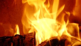 
Detail of burning flames in fireplace in Slow Motion HD VIDEO. Natural fire filling full frame of screen. Quarter speed. Close-up.