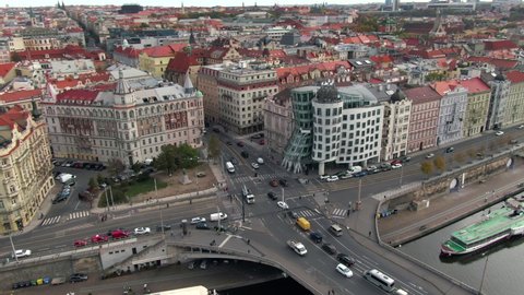 Prague, Czech Republic - October 16, 2019: Daytime aerial view of city traffic and architectural landmark Dancing House building on the banks of the Vltava River in Prague, Czech Republic.