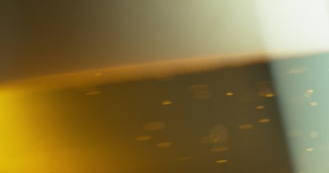 Super Slow Motion Detail Shot of Beer Bubbles in Glass.  The yellow color of this alcool drink can also be used for tea or other drinks of this intense color.
