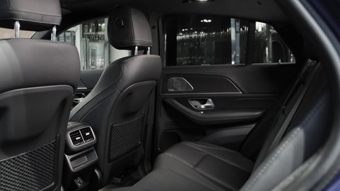 Rear seats of passengers of the new premium SUV. Black leather interior with comfortable seats of the new car.