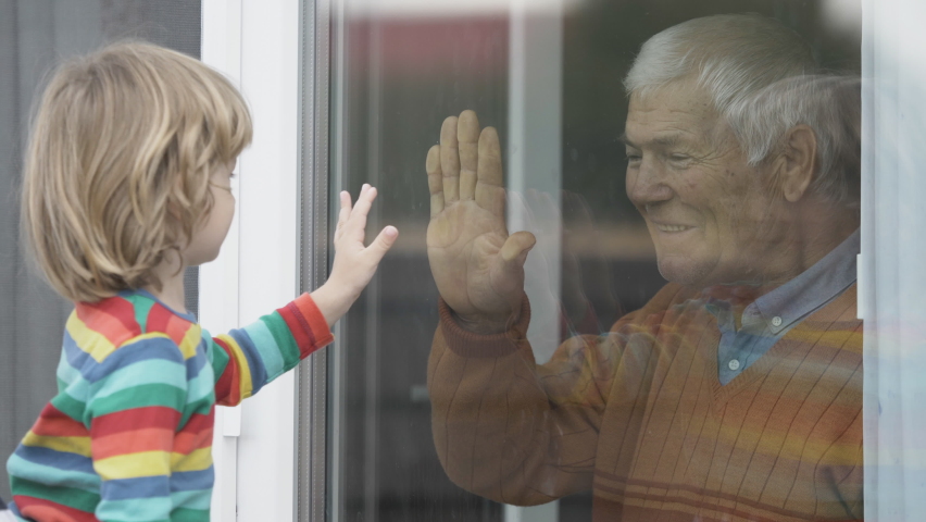 Old man indoor look out window, grandchild outside raises hands to touch grandparent, give five, happy senior, love generation, safety first Royalty-Free Stock Footage #1063423312