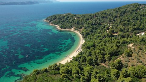 Aerial drone video of beautiful sandy beach of Agia Eleni next to famous banana beach, Skiathos island, Sporades, Greece