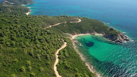 Aerial drone video of secluded emerald beach of Krifi or "hidden beach" in island of Skiathos, Sporades, Greece