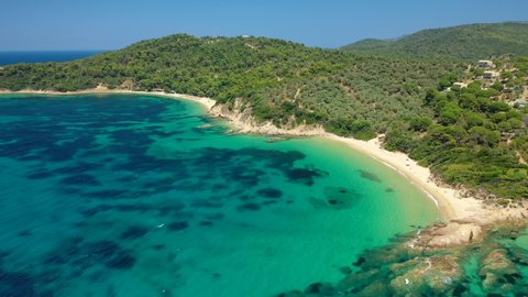 Aerial drone video of paradise beaches of Banana and small Banana covered with pine trees in beautiful island of Skiathos, Sporades, Greece