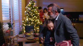 Lovely caucasian family preparing Christmas dinner together. Happy cute girl meeting her lovely grandfather exhcanging gifts for holiday tradition. - Powered by Shutterstock - Get 15% off with code: PIKWIZARD15