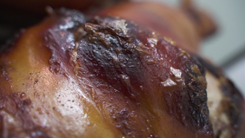 Crispy burned roasted Pig skin - Detail push out slow-motion shot