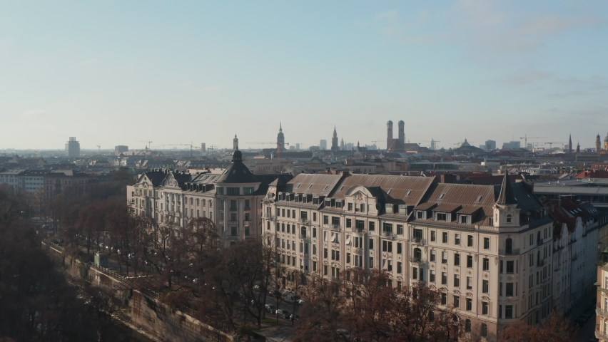 Above the Rooftops of Beautiful Luxury old building with Apartments by Isa Riverside in Munich, Germany on Winter Sunny Day, Epic Aerial Dolly forward