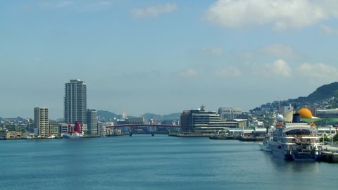 Nagasaki skyline taken from the cruise ship port. Buildings, bridge and the yacht docked in the harbor on a beautiful sunny afternoon