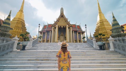 Asian woman visiting Wat Phra Kaew or Emerald buddha temple in Bangkok Thailand