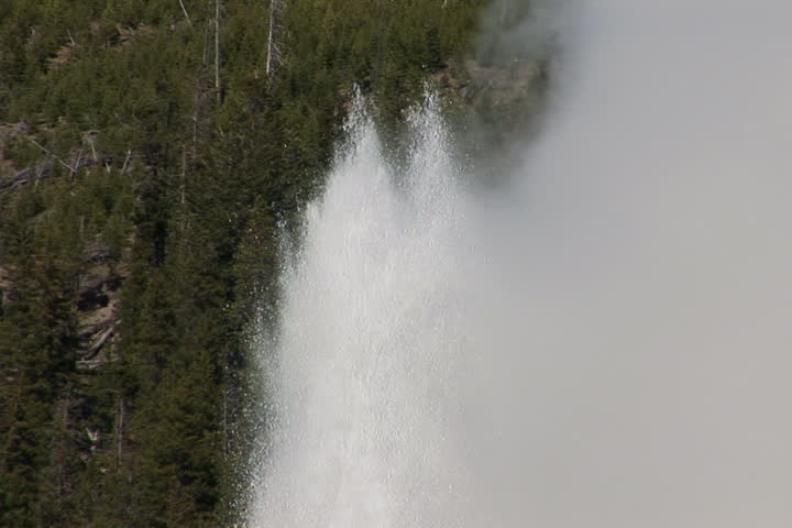 NTSC: Old Faithful erupts - close zoom out. Shot in Yellowstone National Park