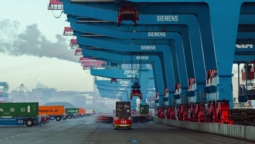 Container ship loading and unloading in deep sea port, Low angle View of business logistic import and export freight transportation by container ship, Automated transport vehicles Container loading cargo Royalty-Free Stock Footage #1063450186