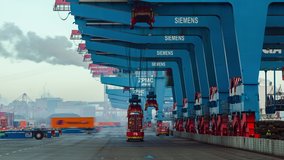 Container ship loading and unloading in deep sea port, Low angle View of business logistic import and export freight transportation by container ship, Automated transport vehicles Container loading cargo - Powered by Shutterstock - Get 15% off with code: PIKWIZARD15