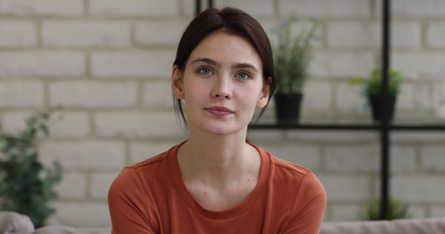Head shot close up young attractive european woman looking at camera, showing sincere positive facial emotions. Happy millennial girl demonstrating healthy toothy smile, satisfied with dental service. Royalty-Free Stock Footage #1063450321