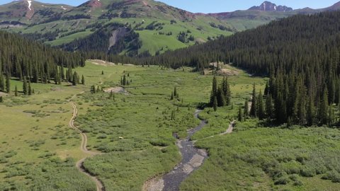High definition aerial video flying down a scenic Colorado valley stream.