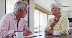Senior caucasian couple with talking to each other discussing finances together at home. retirement senior couple lifestyle living - Powered by Shutterstock - Get 15% off with code: PIKWIZARD15