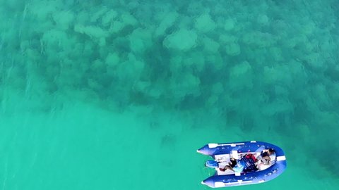 Beautiful aerial view of the sea and a rubber boat ride with sea snorkeling, nature background.の動画素材