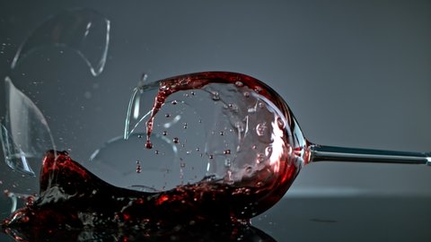 Breaking Glass with Red Wine on Grey Background at 1000 fps.