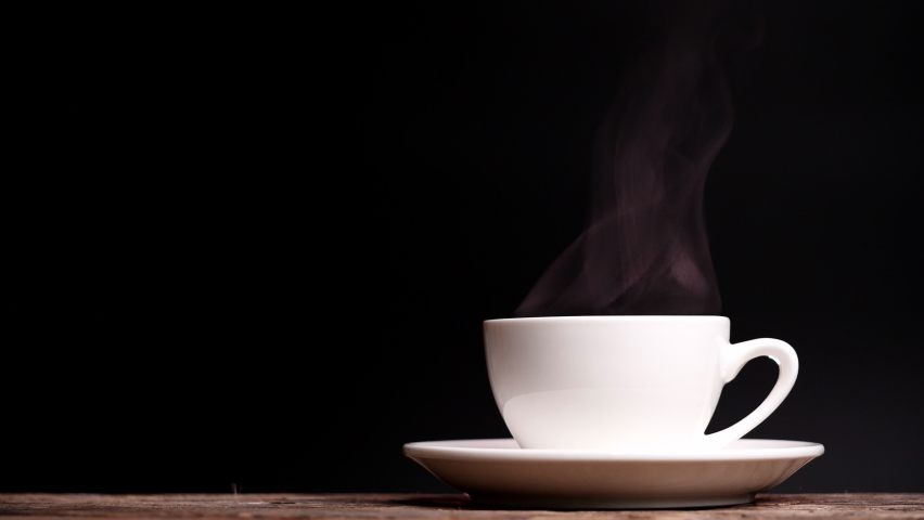 Coffee cup with natural steam smoke of coffee on dark background with copy space, slow motion. Hot Coffee Drink Concept. | Shutterstock HD Video #1063465873