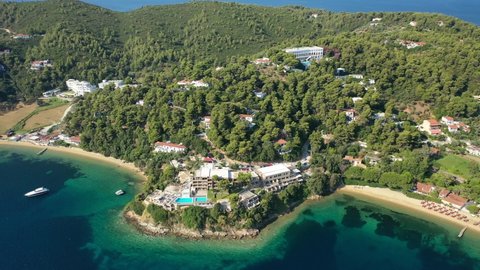 Aerial drone video of famous seaside area and bay of Kanapitsa with many beautiful secluded sandy beaches, Skiathos island, Sporades, Greece