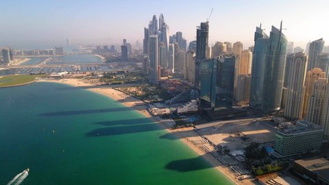 Aerial view of JBR beach and Dubai Marina skyscrapers and luxury buildings in one of the United Arab Emirates travel spots and resorts in Dubai