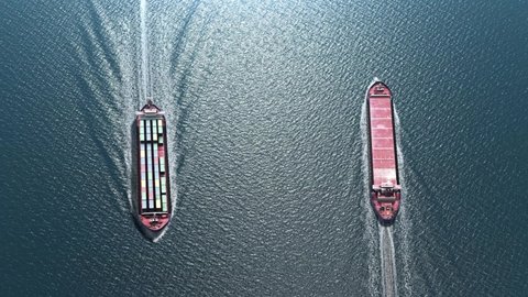 Airplane flies over Cargo ships  with containers in the sea- aerial
, Freight Shipping export and import concept, container ship and plane carries cargo across the ocean. Transportation. Delivery. Log