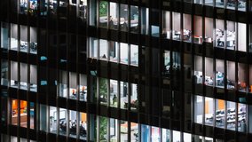 Time lapse of people working late night, office windows view on business center building facade. Corporate business, office worker life, or building exterior architecture concept. Tilt Up - Powered by Shutterstock - Get 15% off with code: PIKWIZARD15