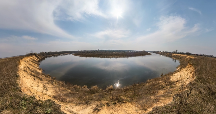 slow transformation of the landscape into tiny planet in blue sky with beautiful white clouds. curvature of space.