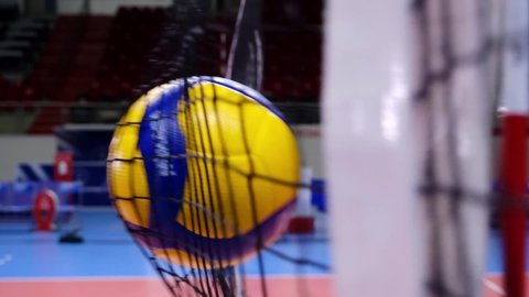 Istanbul, Turkey - October 1, 2020. A Mikasa volleyball hits the net in slow motion.