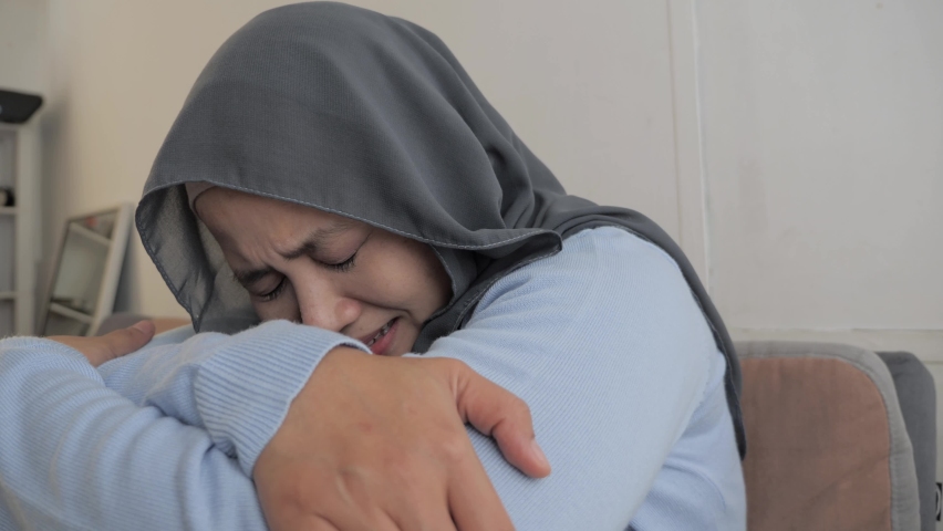 Sad Asian muslim woman wearing hijab crying, suffering from headache pain or having stress depression concept Royalty-Free Stock Footage #1063494025